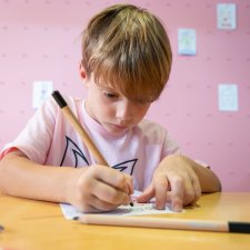 A child drawing at a table