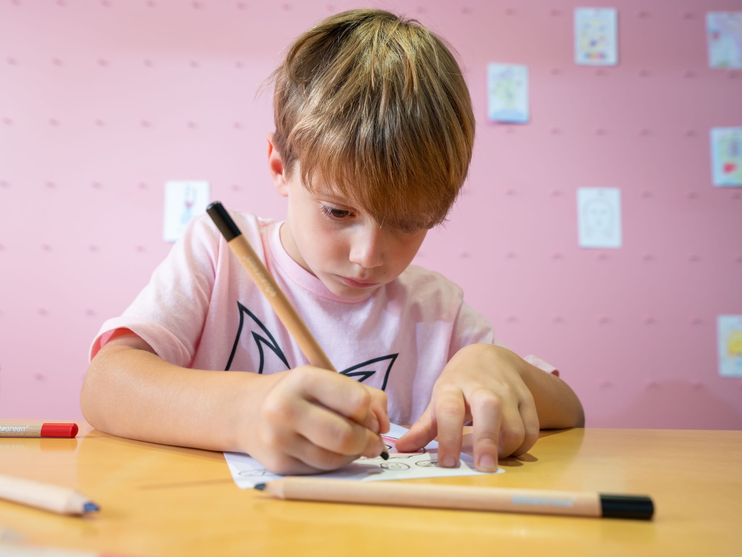 A child drawing at a table