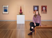 Serena Bentley sitting in the In Bloom exhibition