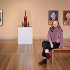 Serena Bentley sitting in the In Bloom exhibition