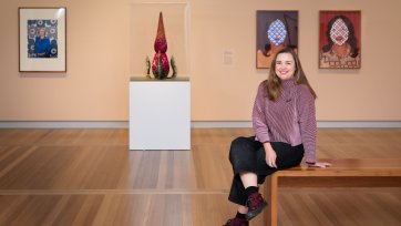 Serena Bentley sitting in the In Bloom exhibition