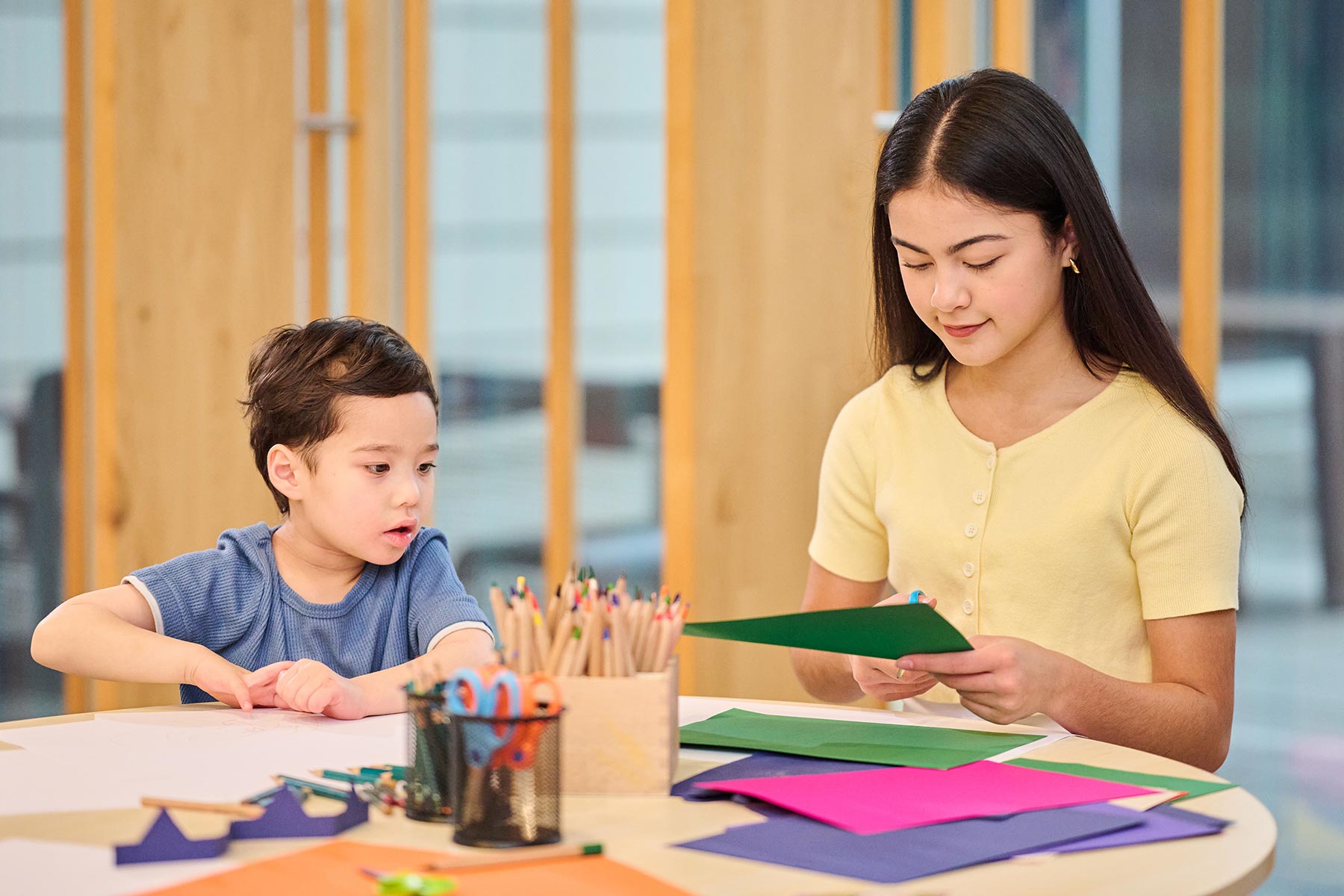Children sitting at a table with craft activities