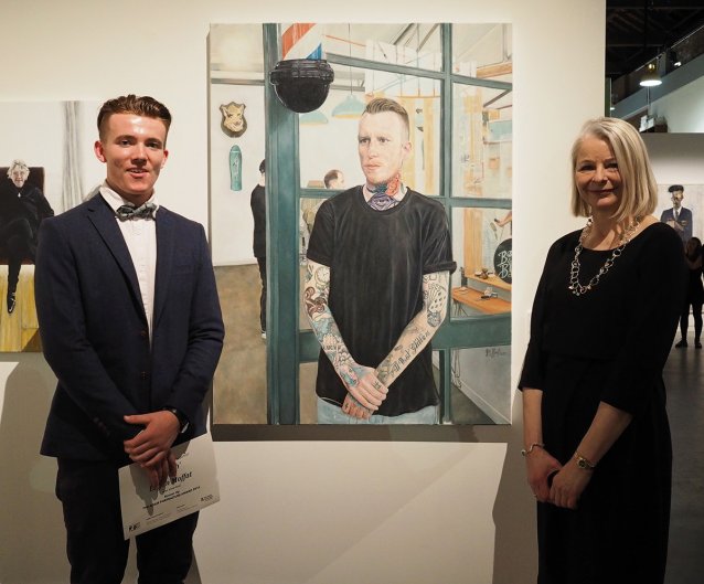Adam Portraiture Award runner up Logan Moffat with judge Mette Skougaard, in front of Moffat’s portrait Stitch on opening night.
