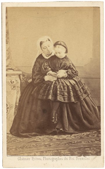 Queen Victoria and Princess Beatrice, looking at a carte de visite of Prince Albert, 1862