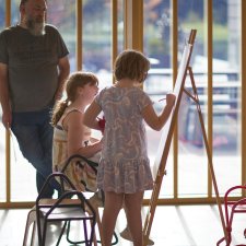 Two children drawing at an easel in the Gordon Darling Hall Two children drawing at an easel in the Gordon Darling Hall