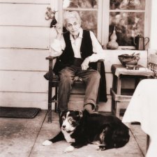 Nora Heysen with her dog sitting outside her home, Hunters Hill, Sydney