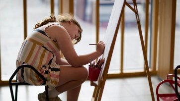 A child drawing at an easel