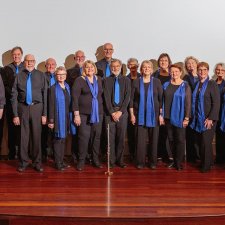 Rhythm Syndicate choir standing together on stage
