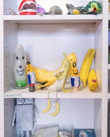 A collection of toys sitting on white shelves A collection of toys sitting on white shelves