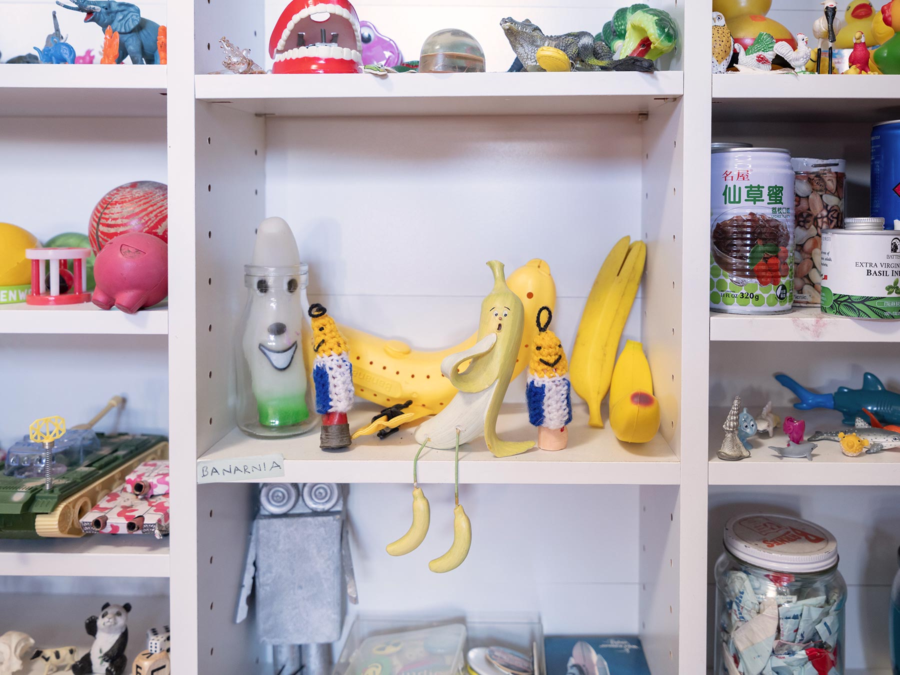 A collection of toys sitting on white shelves