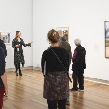 Rebecca Blake leading a tour in the National Photographic Portrait Prize 2025 exhibition
