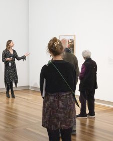 Rebecca Blake leading a tour in the National Photographic Portrait Prize 2025 exhibition