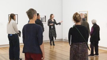 Rebecca Blake leading a tour in the National Photographic Portrait Prize 2025 exhibition