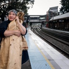 Latai Taumoepeau holding a blanket to her body while standing on the platform at a train station