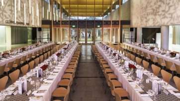 Long tables set for dinner in the Gordon Darling Hall