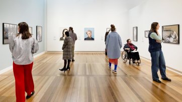 People viewing artworks in a gallery
