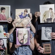 Hands holding a series of books in front of people, hiding their faces