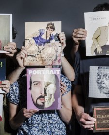 Hands holding a series of books in front of people, hiding their faces