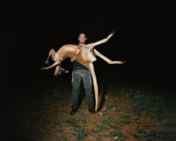 Dwayne John, off-siding a commercial kangaroo shooter, Adnyamathanha Country, Plumbago Station, South Australia, 2017 (printed 2026) Adam Ferguson