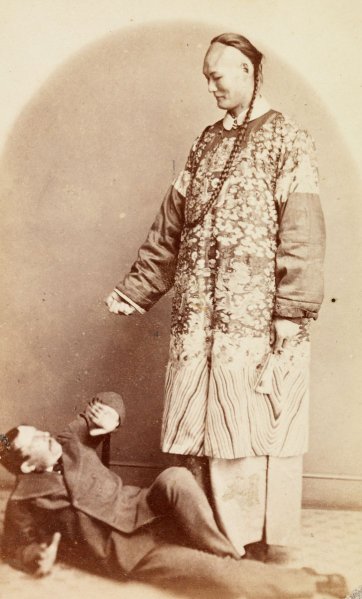Chang the Chinese giant with his manager cowering on the floor, c. 1871 by an unknown artist Chang the Chinese giant with his manager cowering on the floor, c. 1871 by an unknown artist