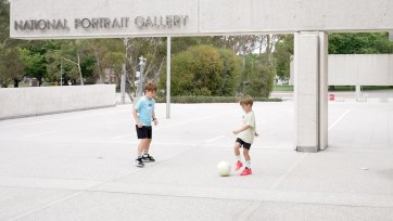Children with a soccer ball in front of the National Portrait Gallery