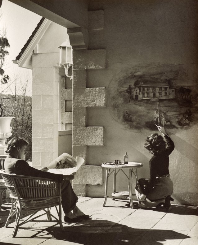 Helen Blaxland watching Jocelyn Rickards painting the mural at Brush, 1946