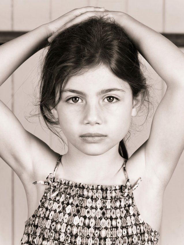 Young girl in a dance class waiting to be photographed, 2010