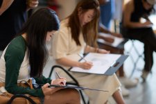 People drawing on paper notepads People drawing on paper notepads