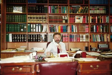 Alan sitting at his desk at Aickin Chambers, Melbourne, c. 1990