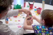 Grandparents and children at a table with craft activities Grandparents and children at a table with craft activities