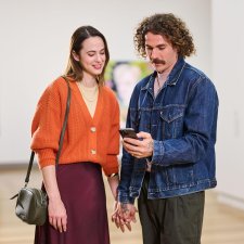 People looking at a phone app