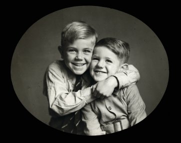 Two boys, sons of Mr JE Crawford, one with arms around the other by Ruth Hollick