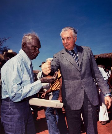 Prime Minister Gough Whitlam pours soil into the hand of traditional land owner Vincent Lingiari