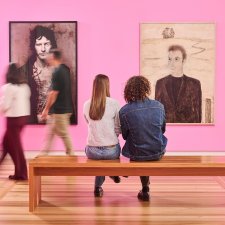 People sitting in front of artworks in Gallery Four People sitting in front of artworks in Gallery Four