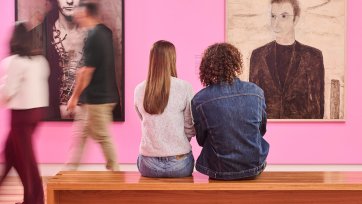 People sitting in front of artworks in Gallery Four