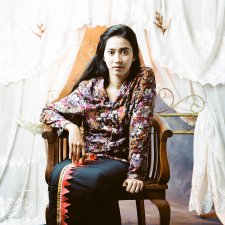 Potret diri di depan kelambu terbuka (Self portrait before the open mosquito net), 2009 by Herra Pahlasari