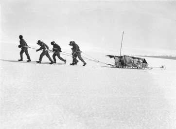 Sledge party rising on the slopes of Commonwealth Bay, Mawson in lead Frank Hurley
