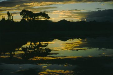 Sunset is reflected in the Lake Pedder waters as a storm approaches, Tasmania