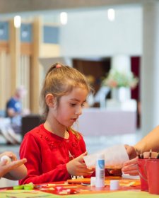 Children doing activities at a table in the gallery