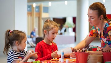 Children doing activities at a table in the gallery