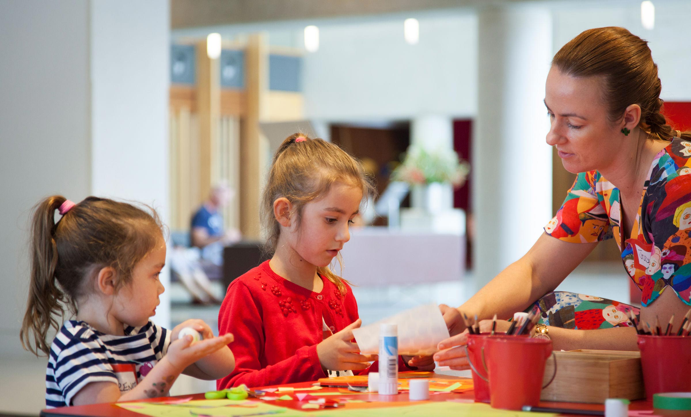 Children doing activities at a table in the gallery