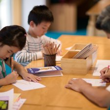Children sitting at a table and drawing