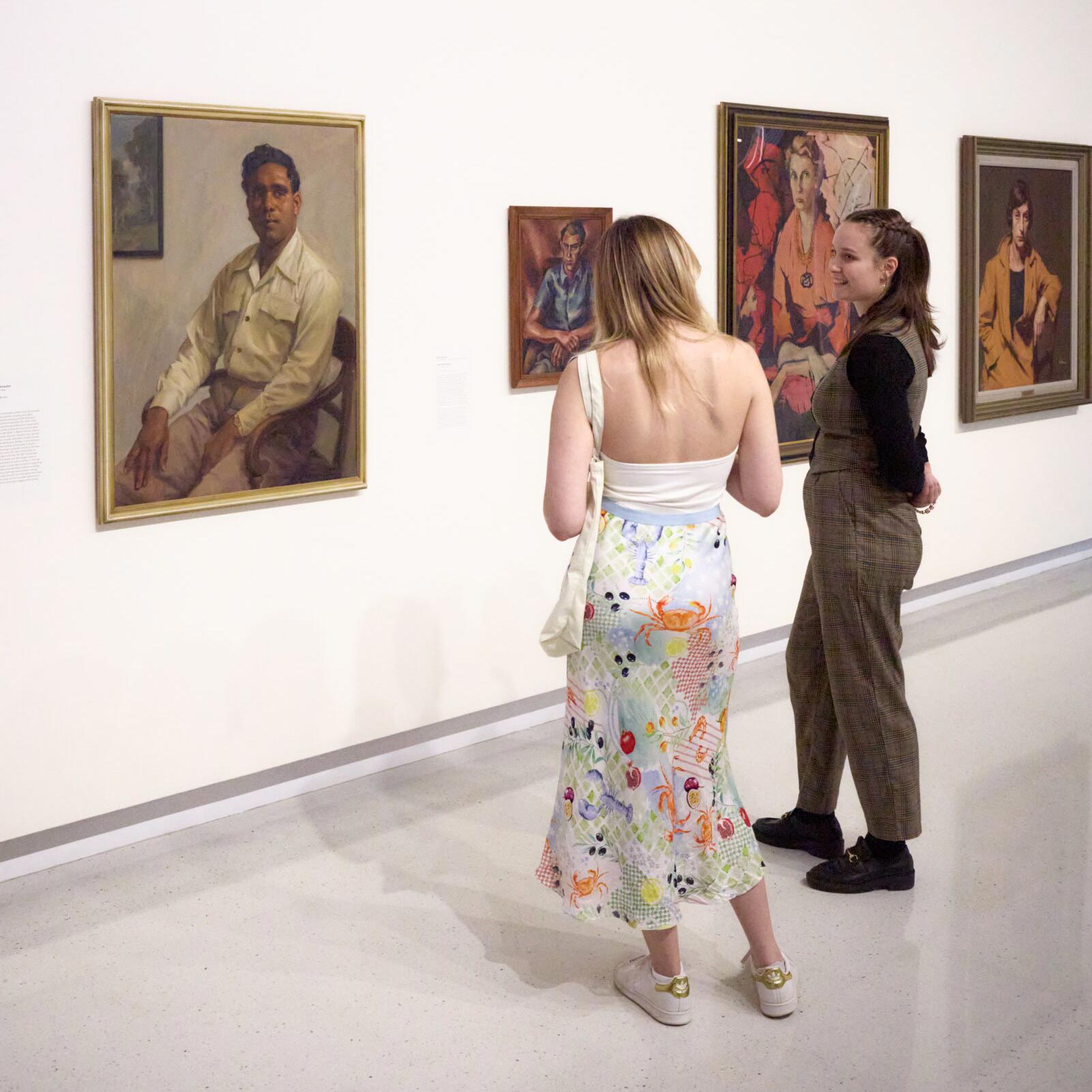 Visitors looking at Harold Blair, 1948 by Ernest Buckmaster. Purchased 2010 © Estate of Ernest Buckmaster