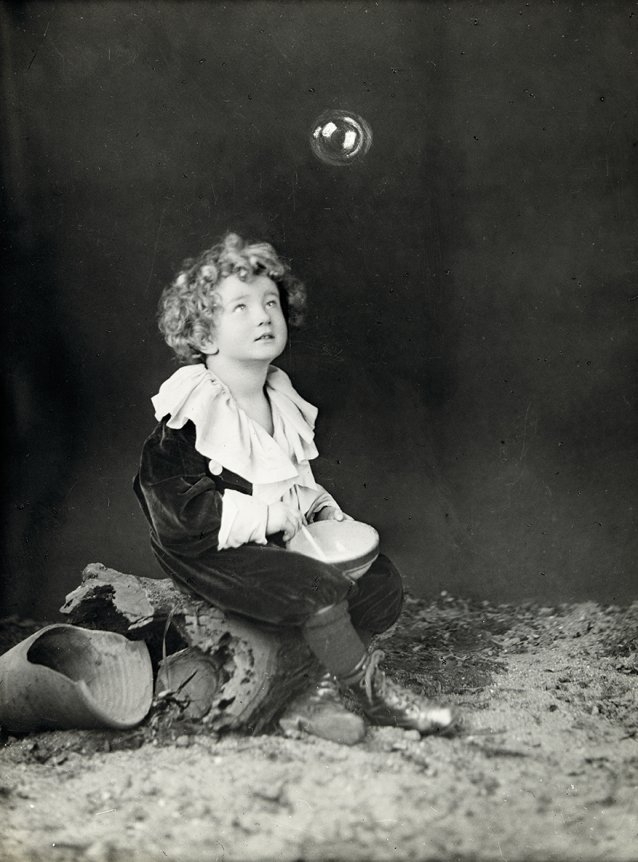 Young child blowing a bubble