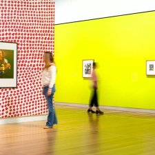 Two people looking at artworks