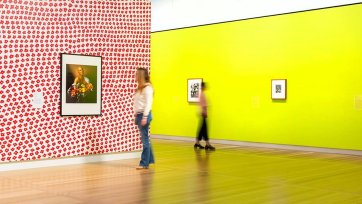 Two people looking at artworks