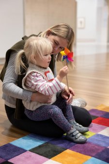 A child playing with a flower in the Gallery