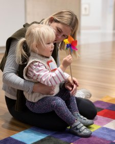 A child playing with a flower in the Gallery