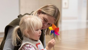 A child playing with a flower in the Gallery