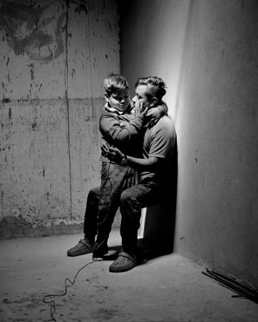 Carlos Soyos, 34, a migrant from Guatemala City, Guatemala and his son, Enderson Soyos, 8, take a self portrait at El Buen Samaritano migrants shelter, Juarez, Chihuahua, Mexico, 2021 Adam Ferguson